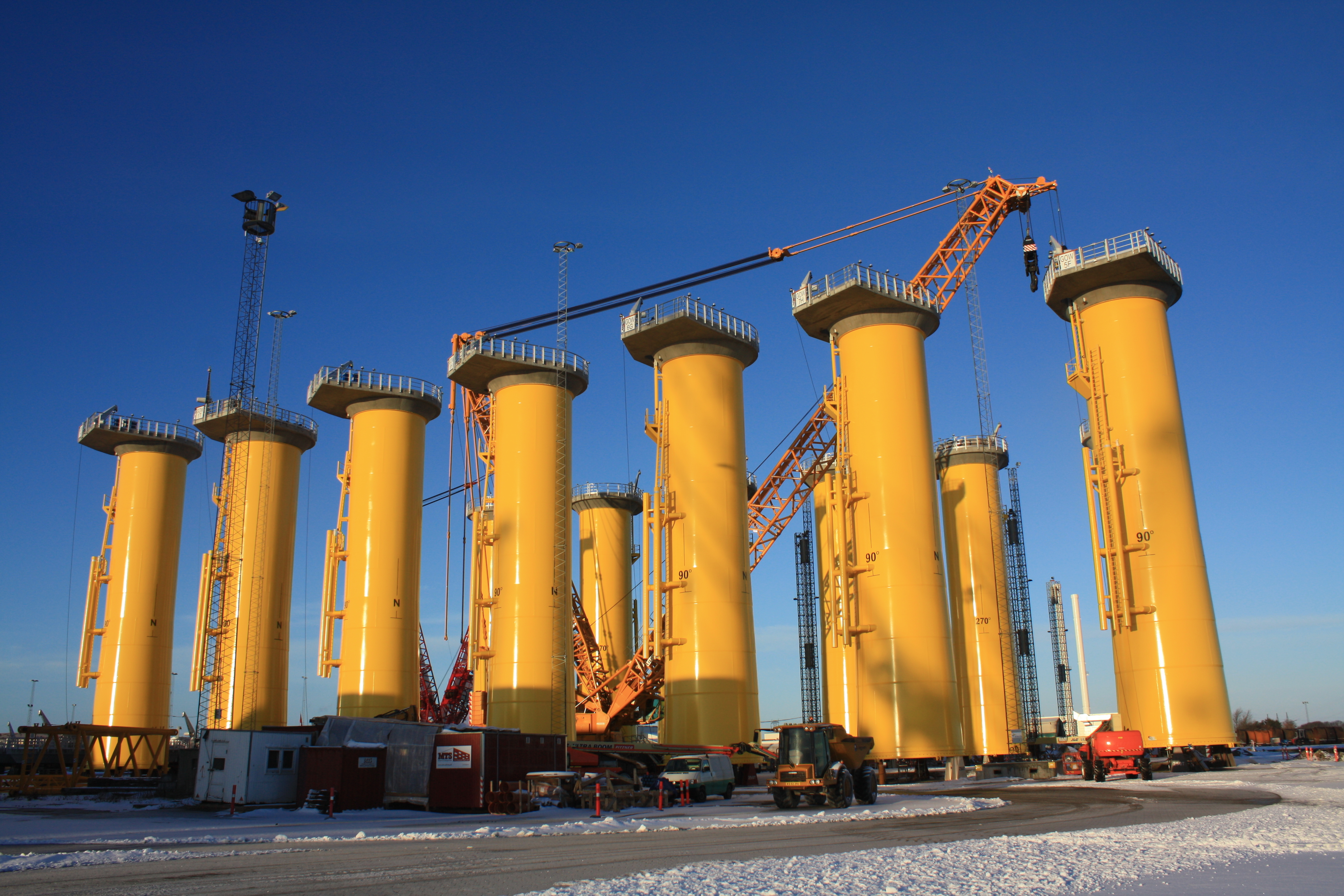 A photo of yellow tubular transition pieces at Bladt Industries' site in Denmark