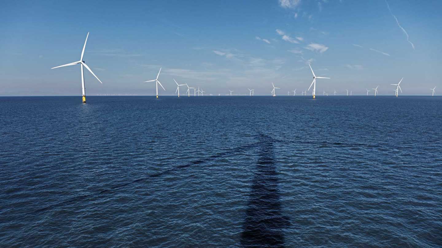 An offshore wind farm with a wind turbine shadow on the water surface