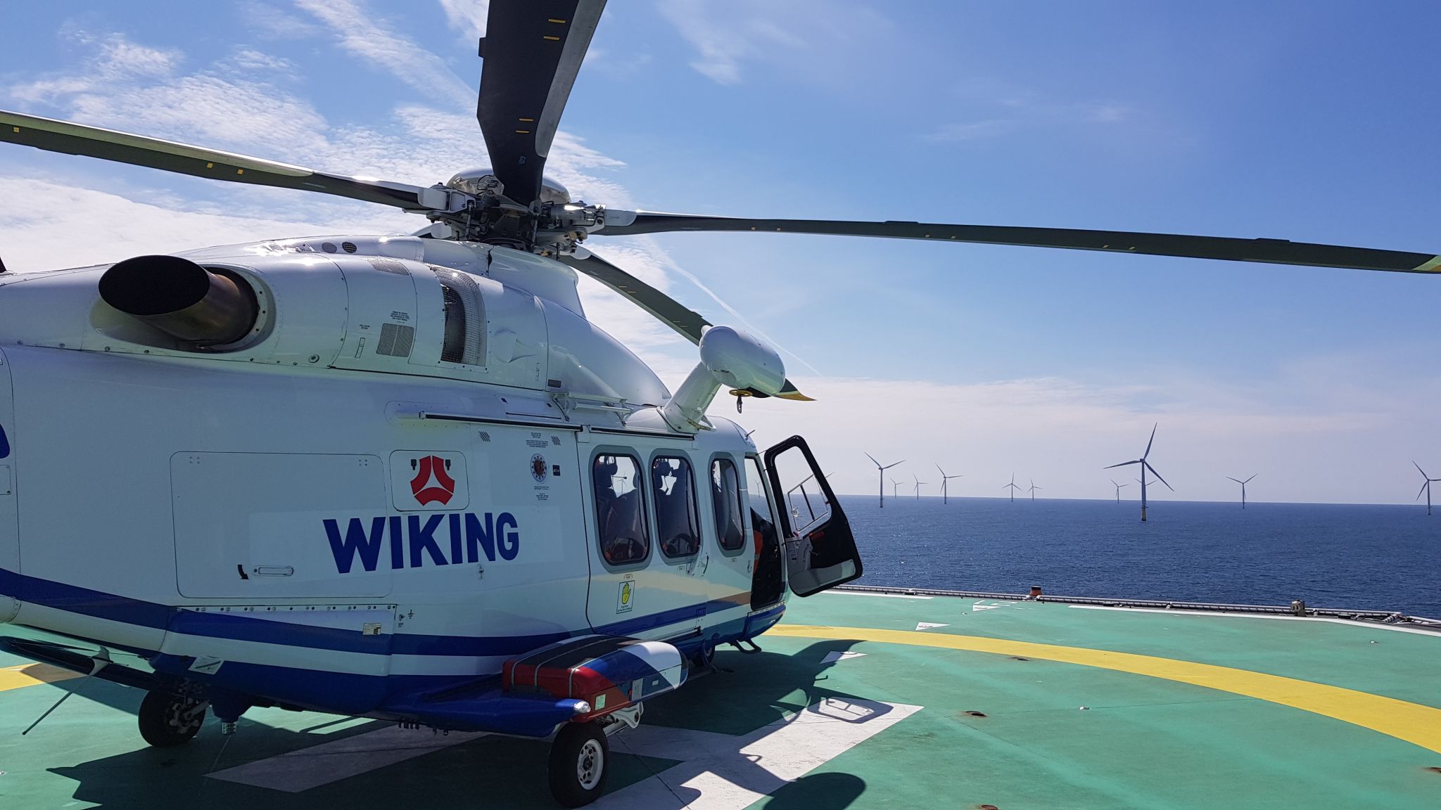 A WIKING offshore helicopter on a deck at an offshore wind farm