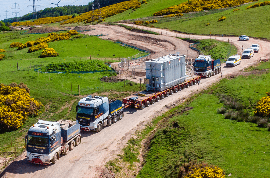 An aerial photo of a convoy with the Neart na Gaoithe shunt reactor travelling to Crystal Rig