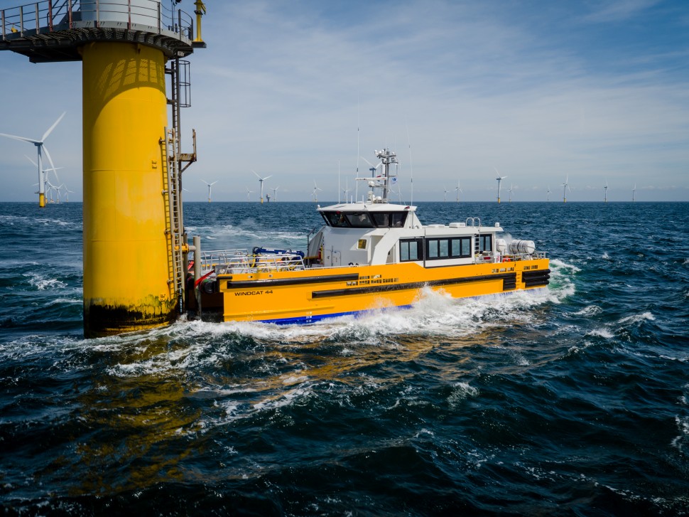 A photo of a Windcat crew transfer vessel docking onto a wind turbine