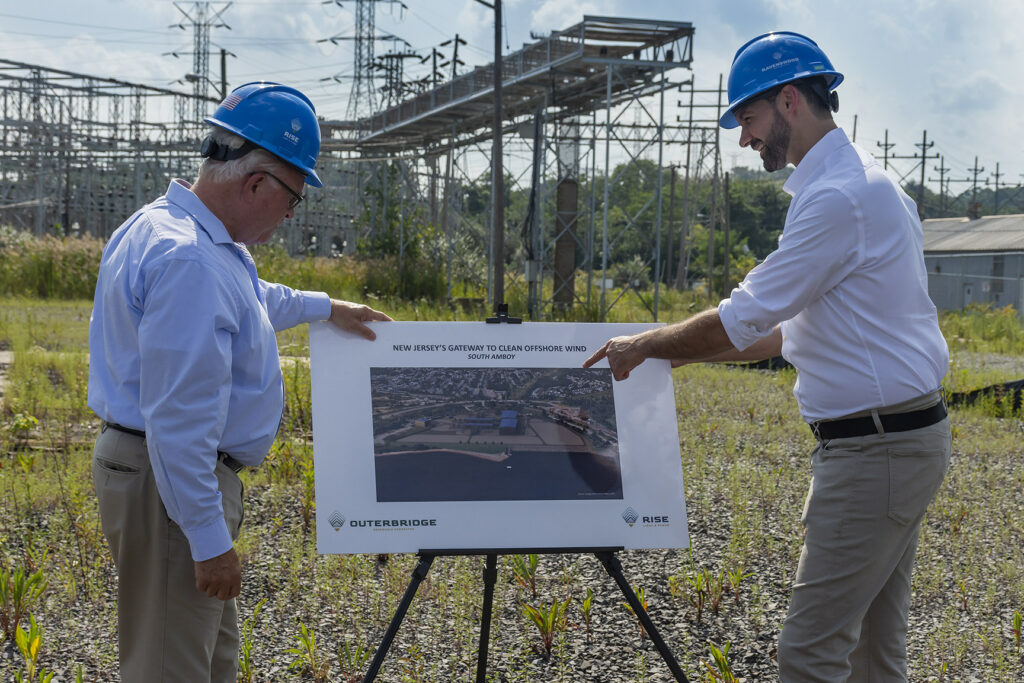 A photo of South Amboy Mayor Fred Henry and Rise Light & Power CEO Clint Plummer review future plans to transform the former coal-fired Werner Generating Station into a clean energy hub