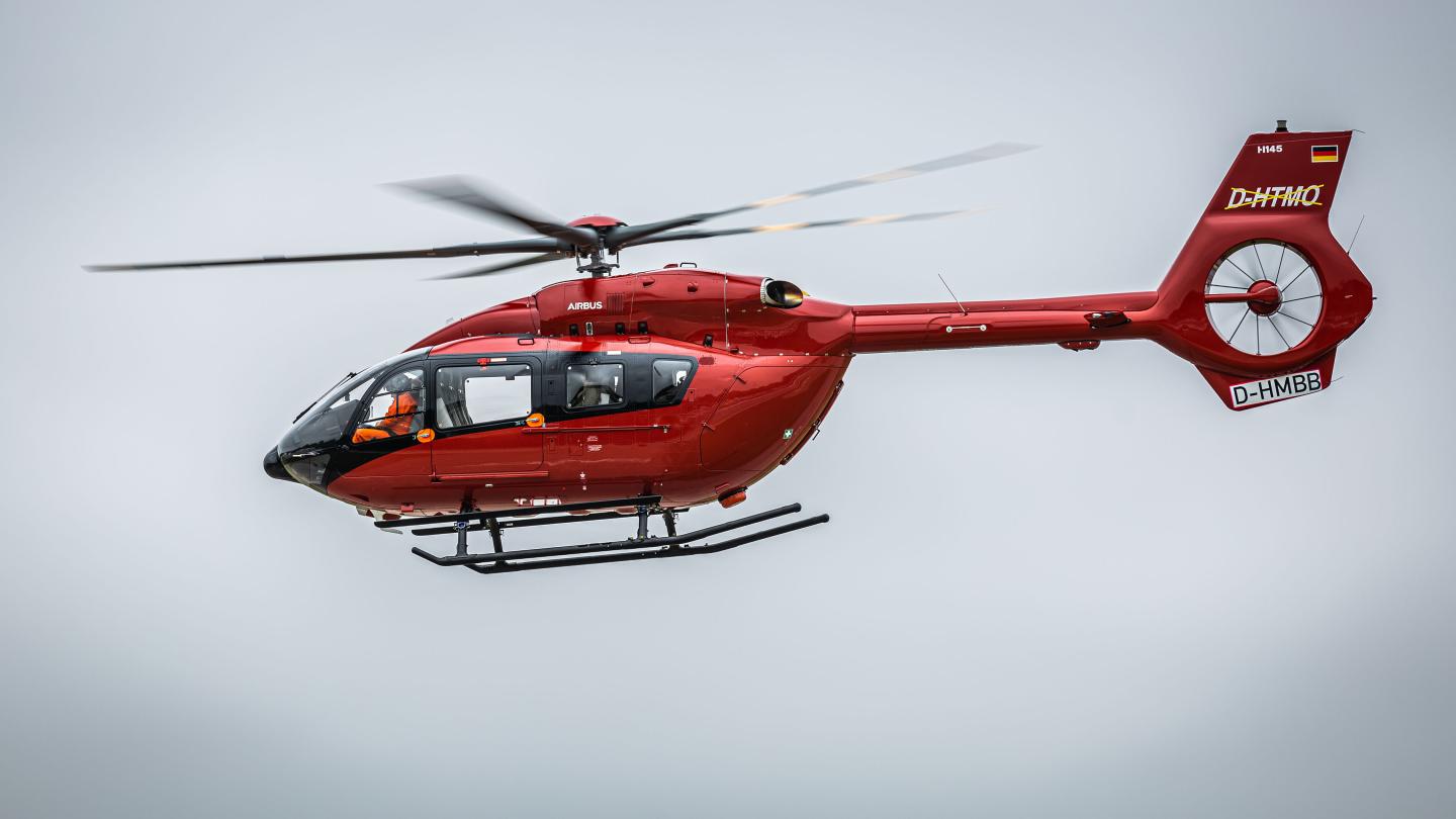 A ohoto of An Airbus H145 helicopter with a five-bladed rotor system in flight