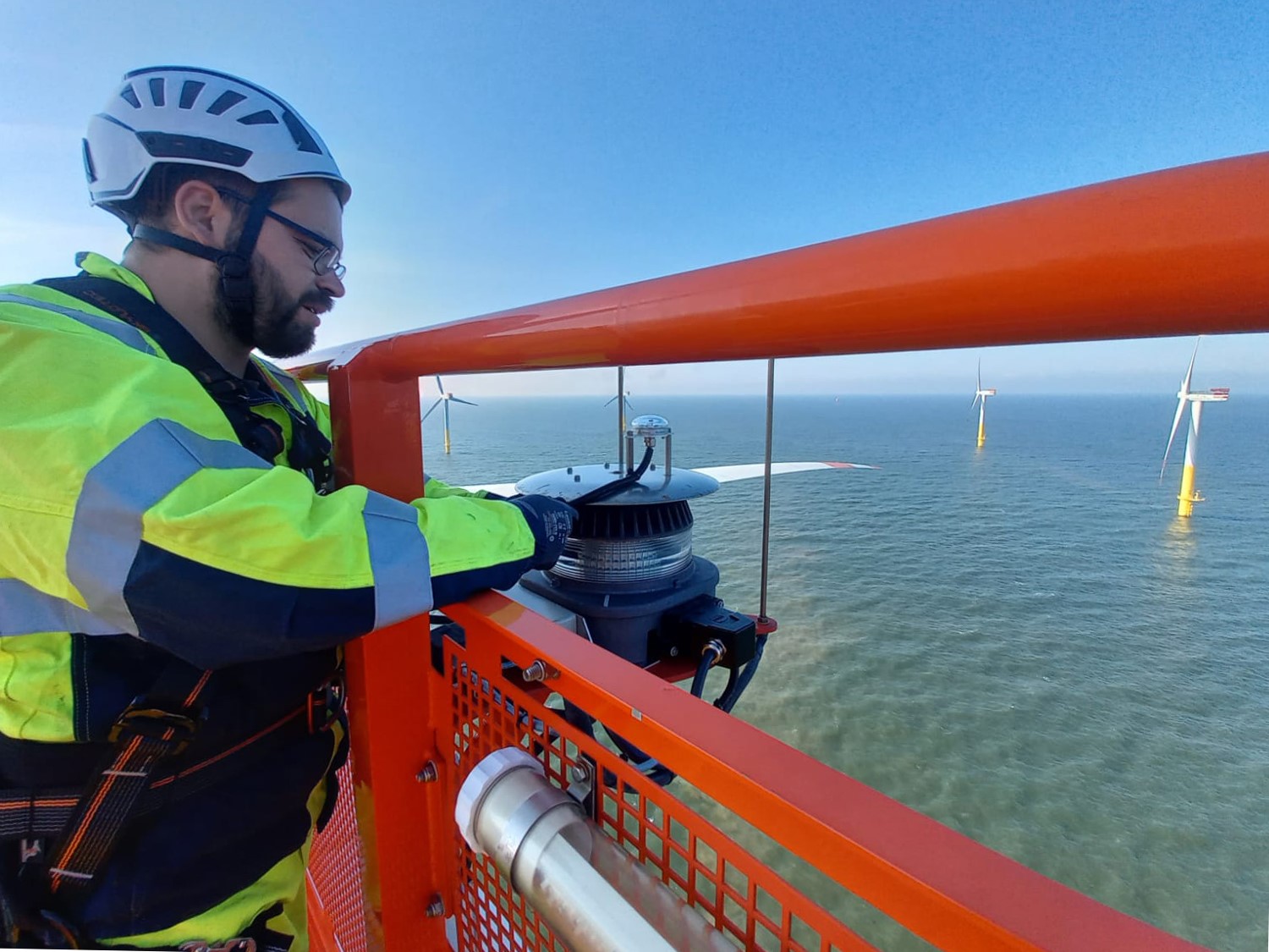 A photo of Deutsche Windtechnik staff installing the Aircraft Detection Light System on Nordergrunde offshore wind farm