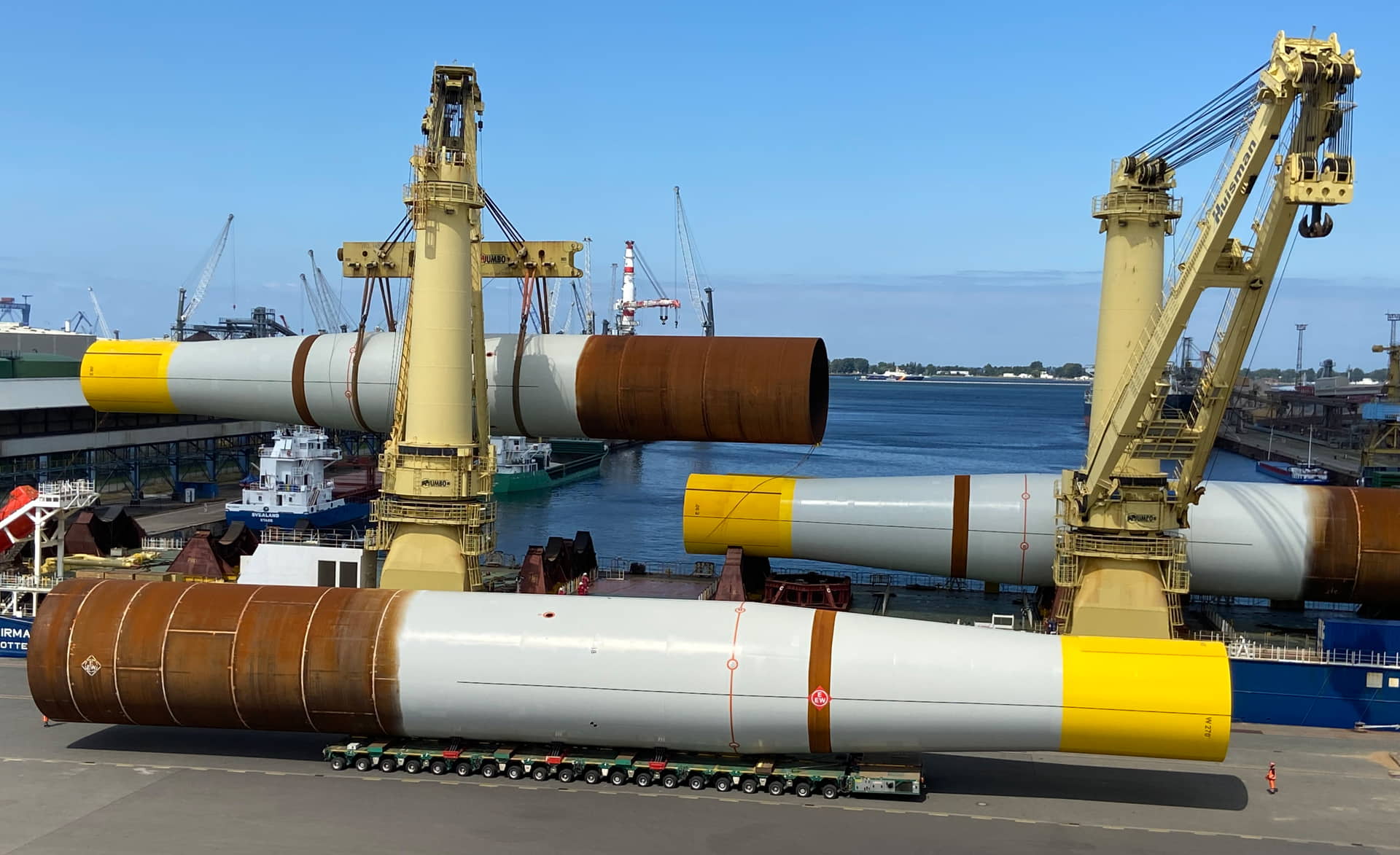 A photo of monopiles being loaded at EEW SPC quayside in Rostock, Germany