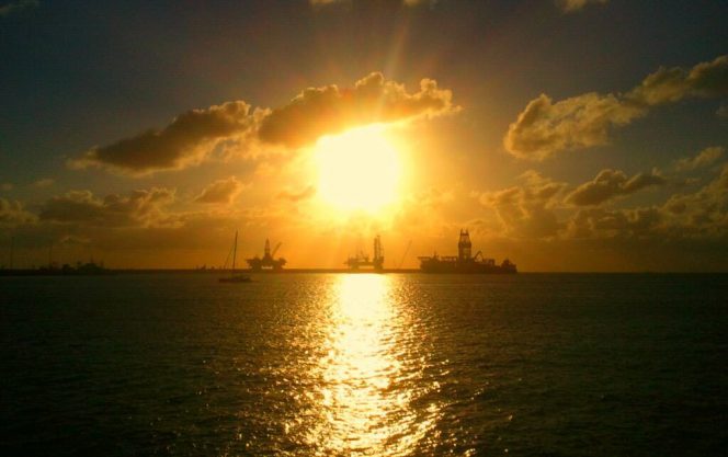 Offshore drilling rigs, sunset, image