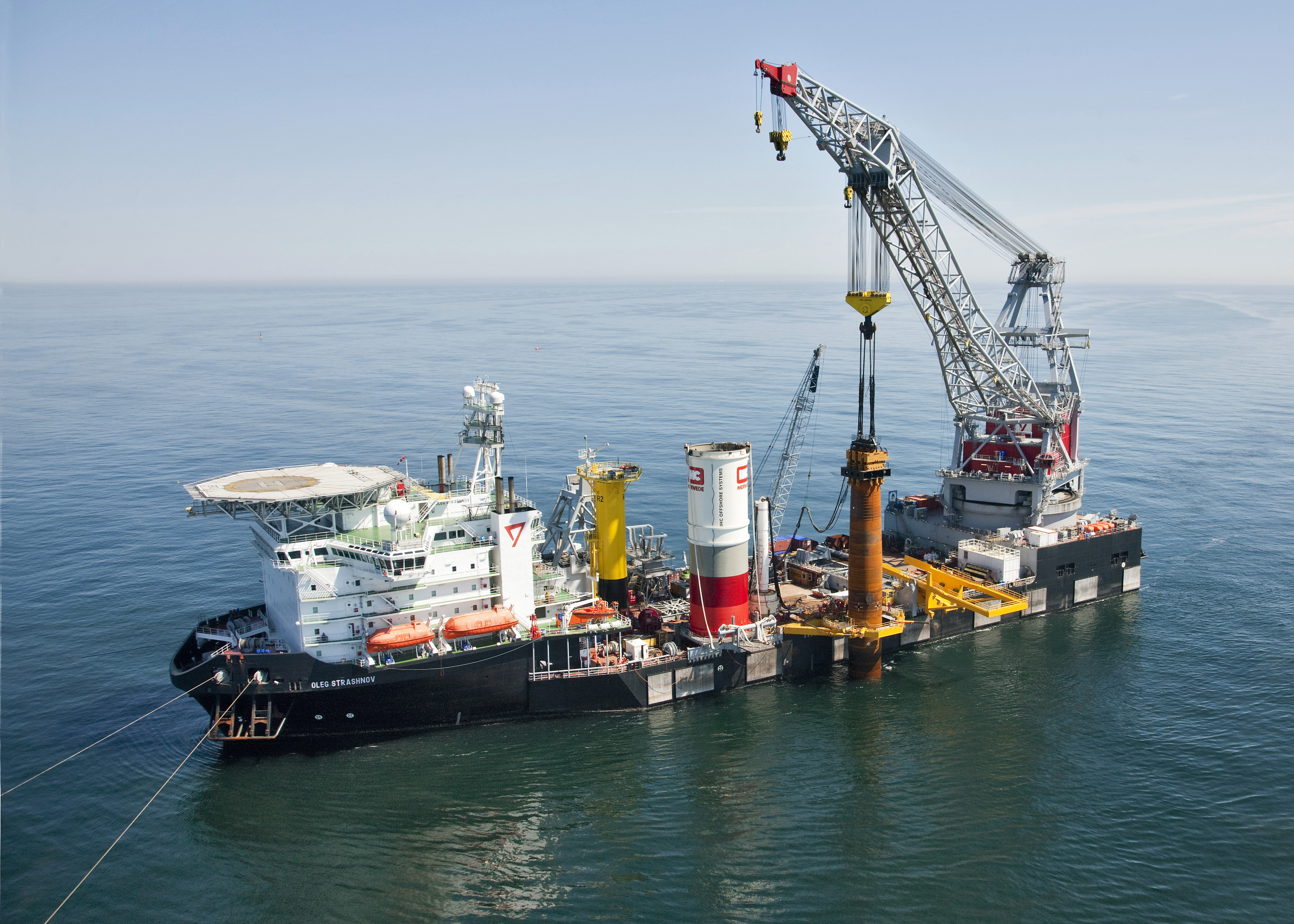 A photo of a vessel at sea installing Riffgat monopiles with vibro tool