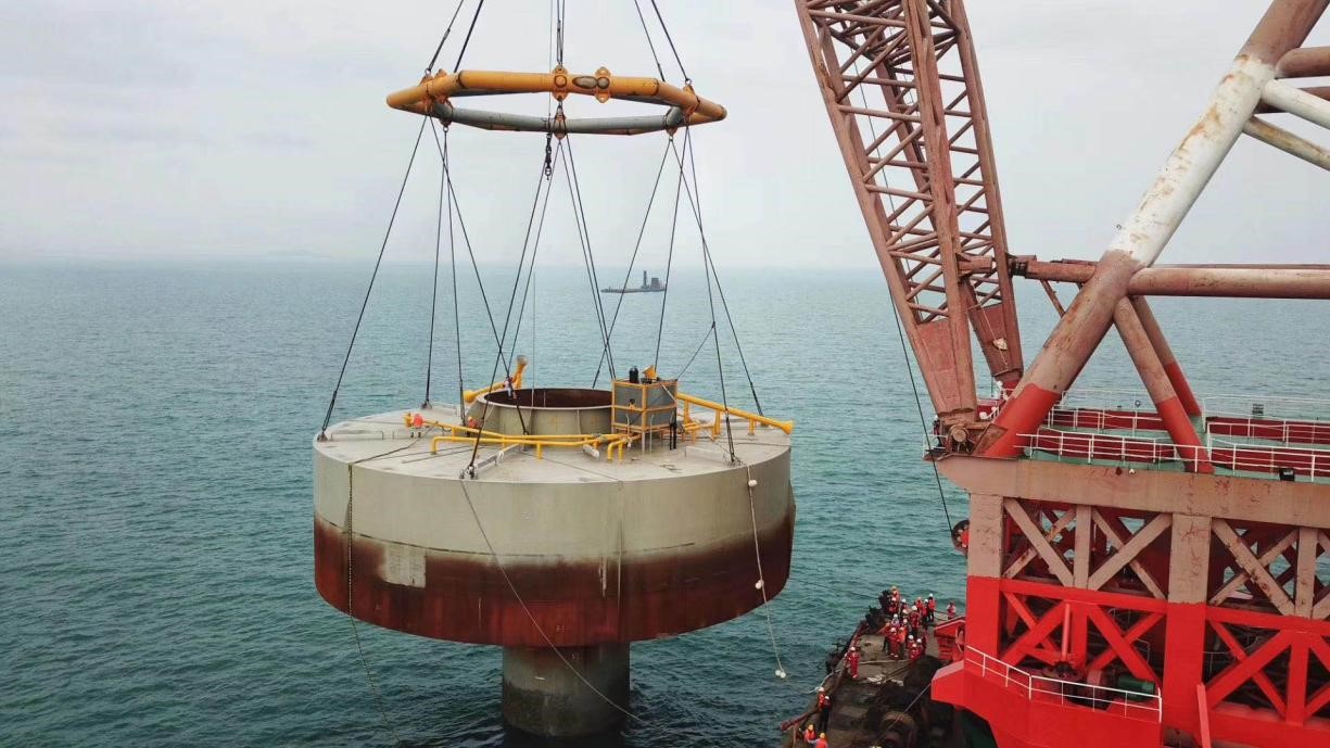 A close-up photo of the monopile-caisson foundation being installed at the offshore wind project site