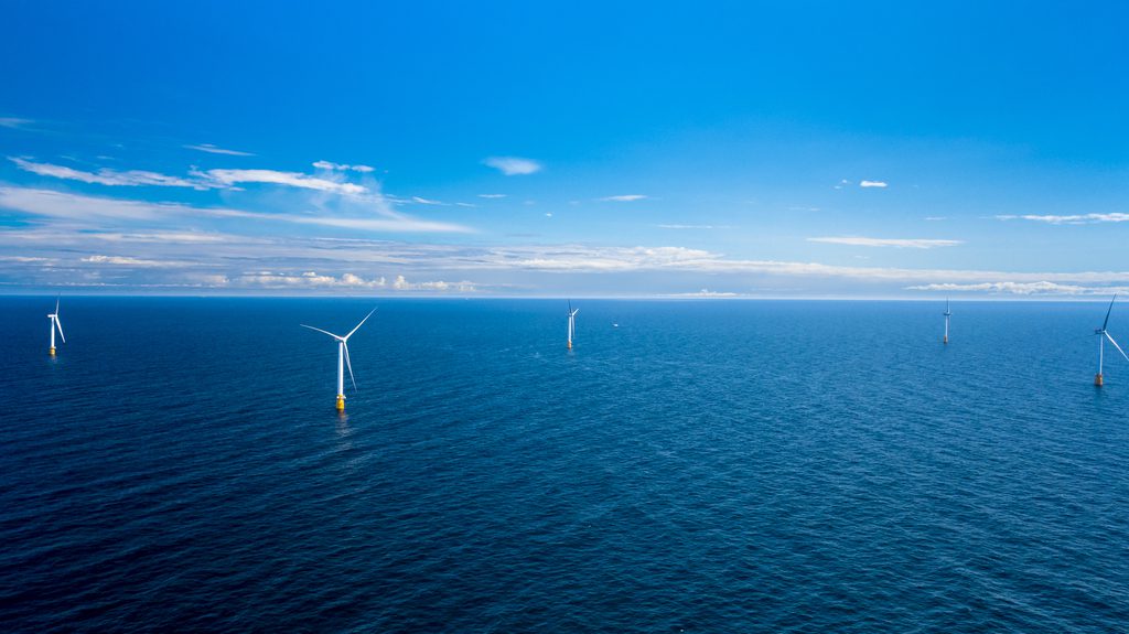 A photo of an offshore wind farm on a calm day at sea