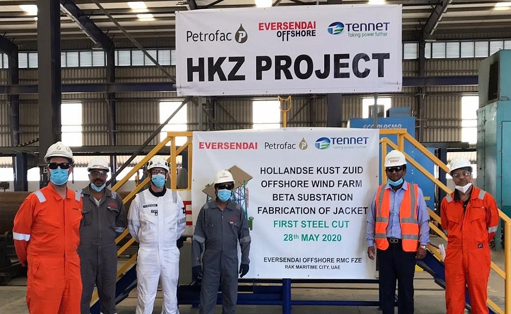 A photo from HKZ Beta steel-cutting ceremony showing banner and construction team