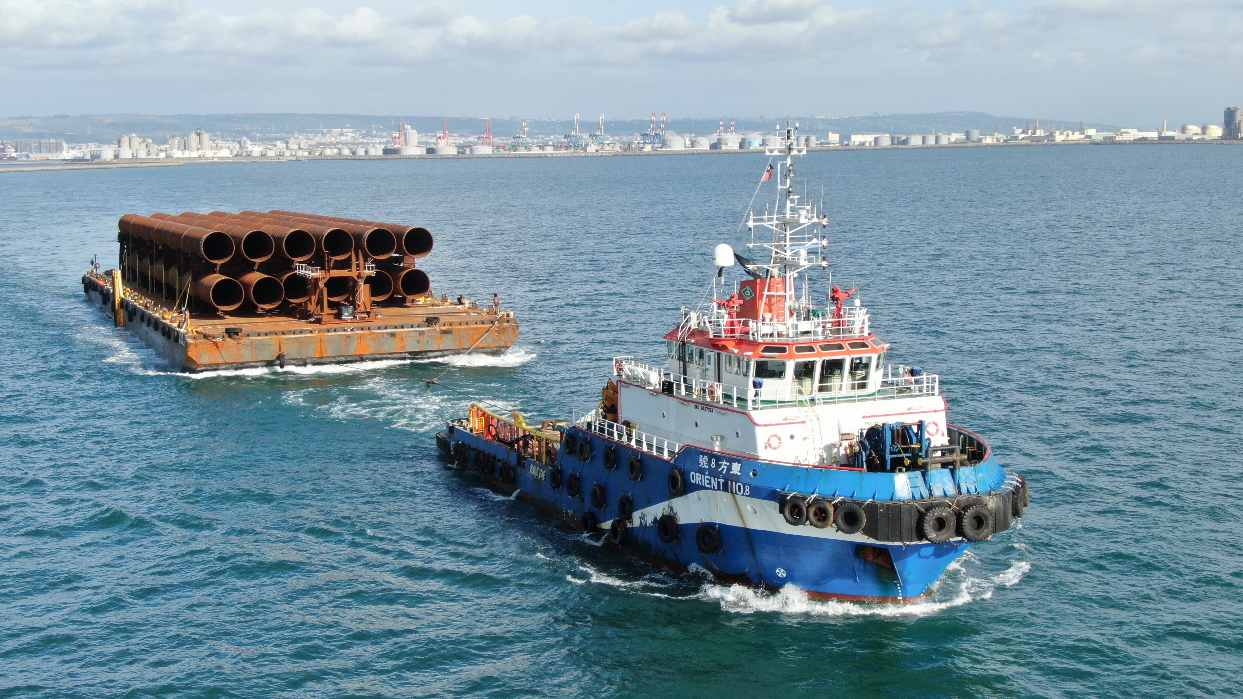 Pin piles for Changhua Phase 1 being towed onboard a barge by the anchor handling tug Orient No. 8