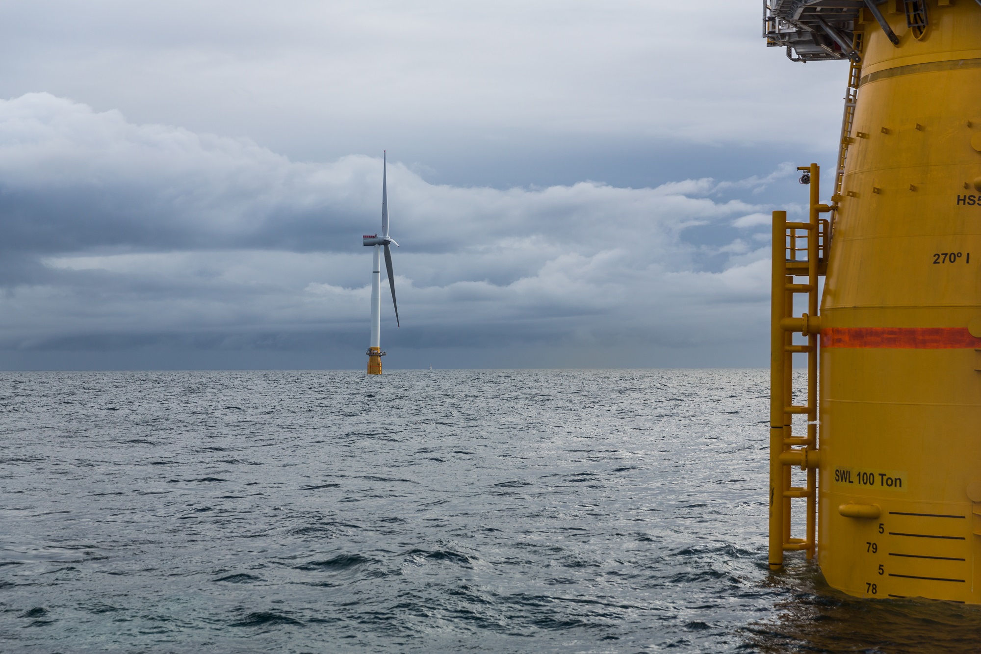 A photo of Hywing Scotland floating wind farm, with yellow turbine foundation close-up