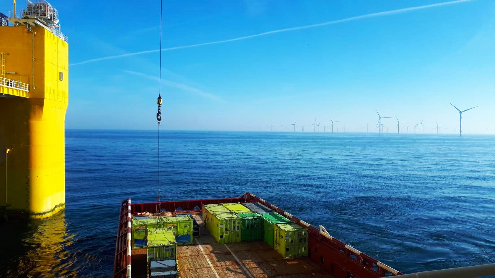 Cargostore containers in front of an offshore wind farm