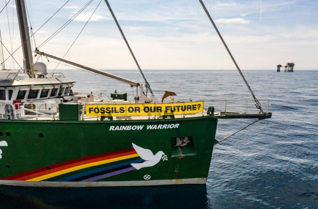 Rainbow Warrior and Dan Bravo in the background; Source: Greenpeace