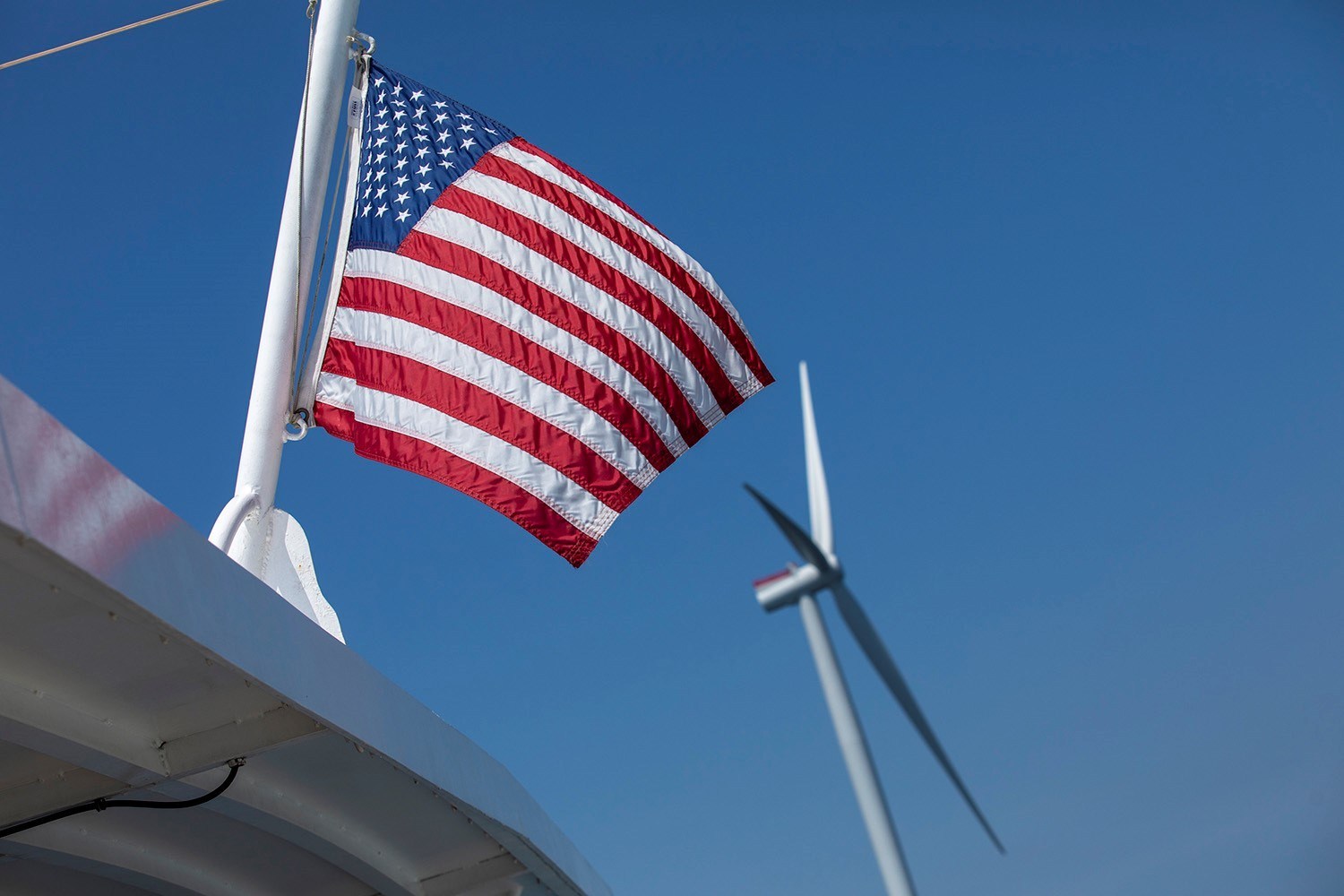 USA flag with CVOW wind turbine in the background