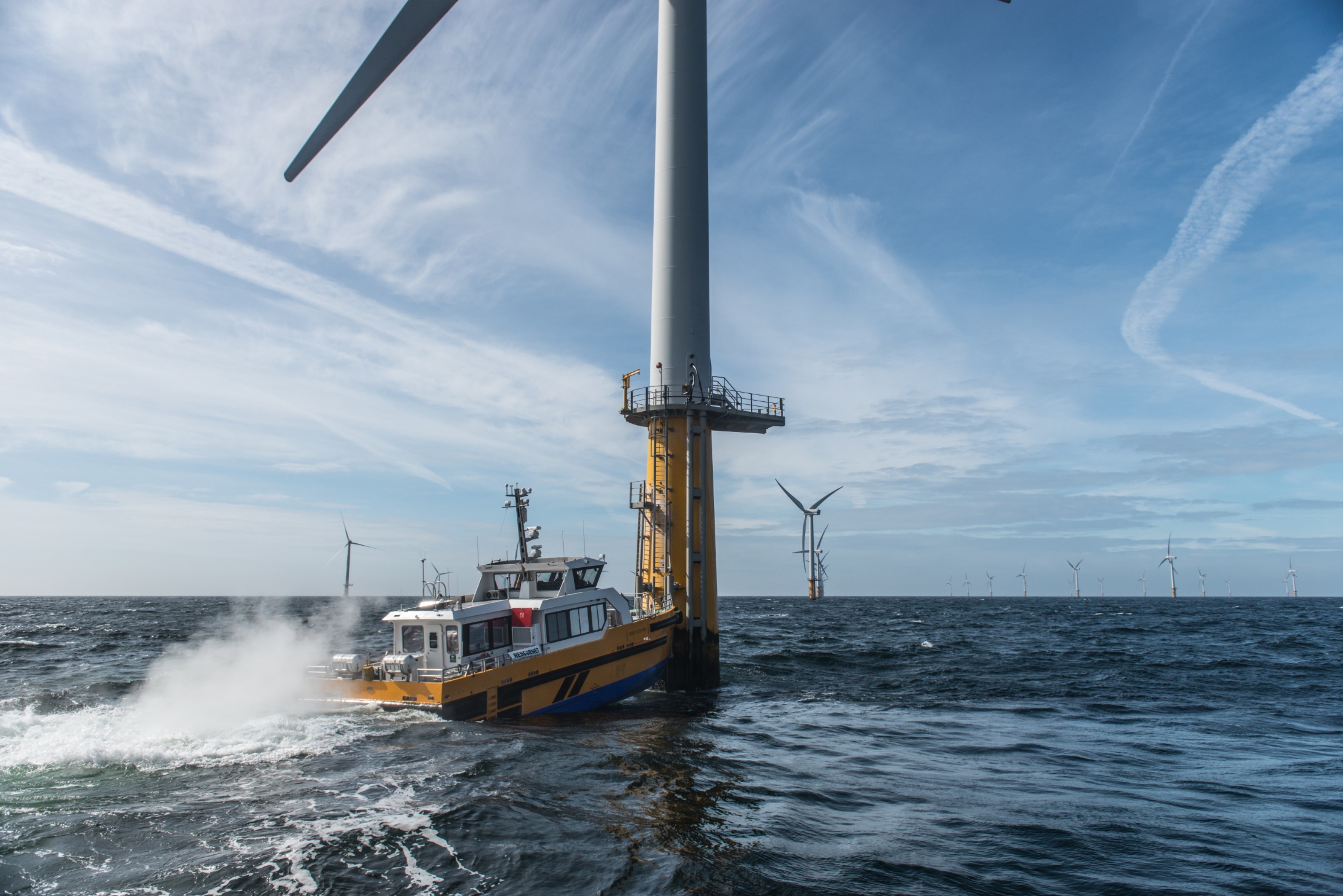 A crew transfer vessel at an offshore wind turbine