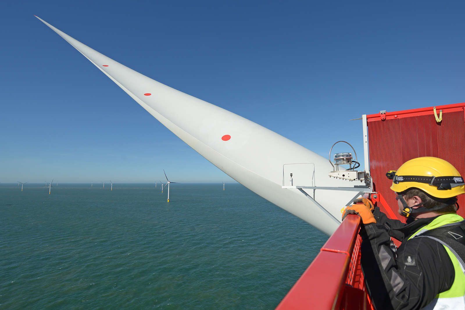 An offshore wind technician on top of a wind turbine at the UK's Galloper offshore wind farm