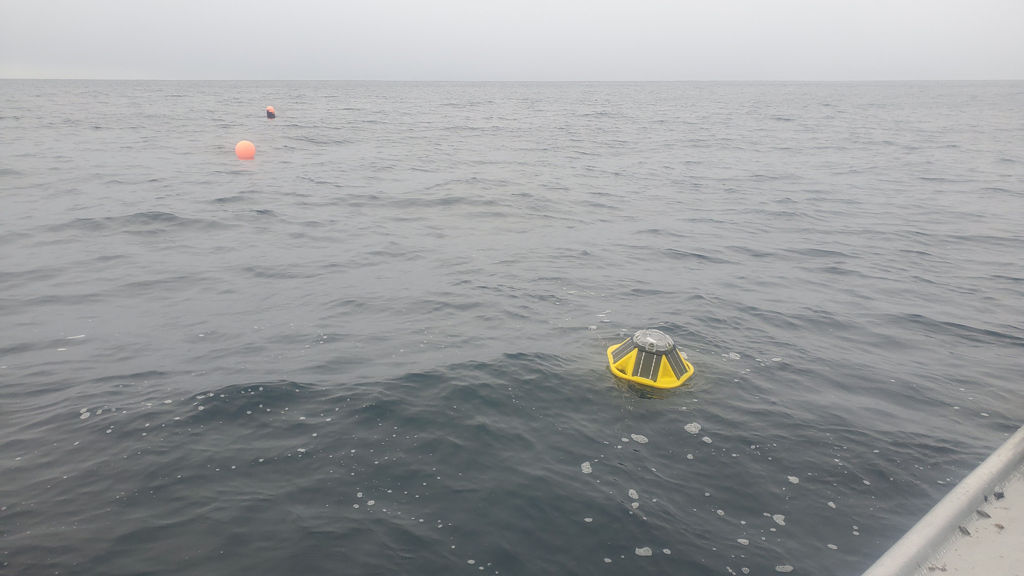 A photo of a Sofar Ocean wave buoy floats on top of the ocean waves off Cannon Beach near Yakutat (Courtesy of Stephanie Jump)