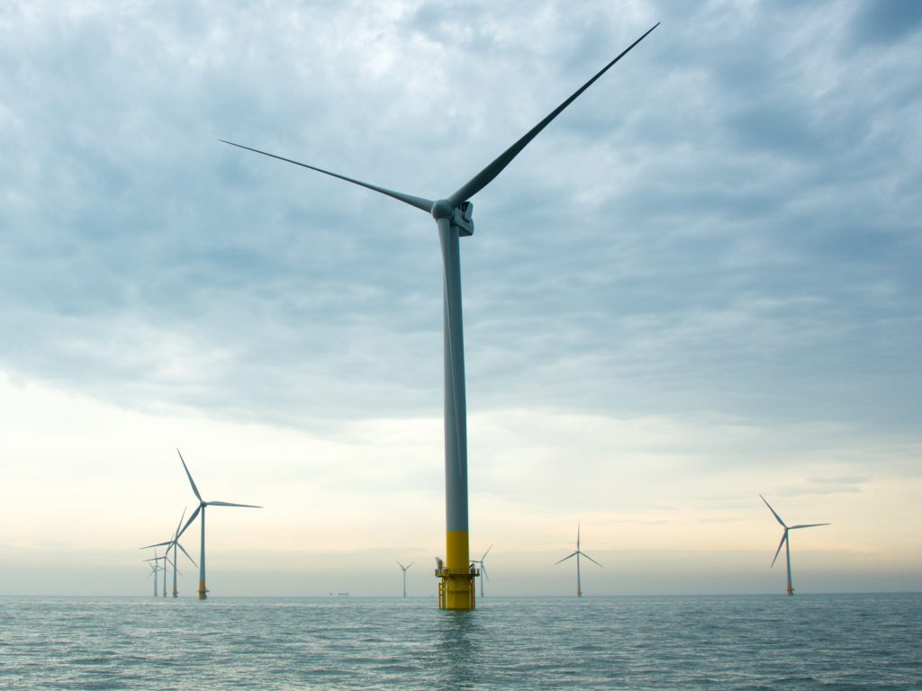 An offshore wind farm with a wind turbine up close