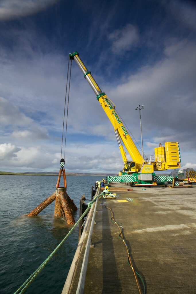 Photo showing the lifting of the tripod (Courtesy of Colin Keldie)