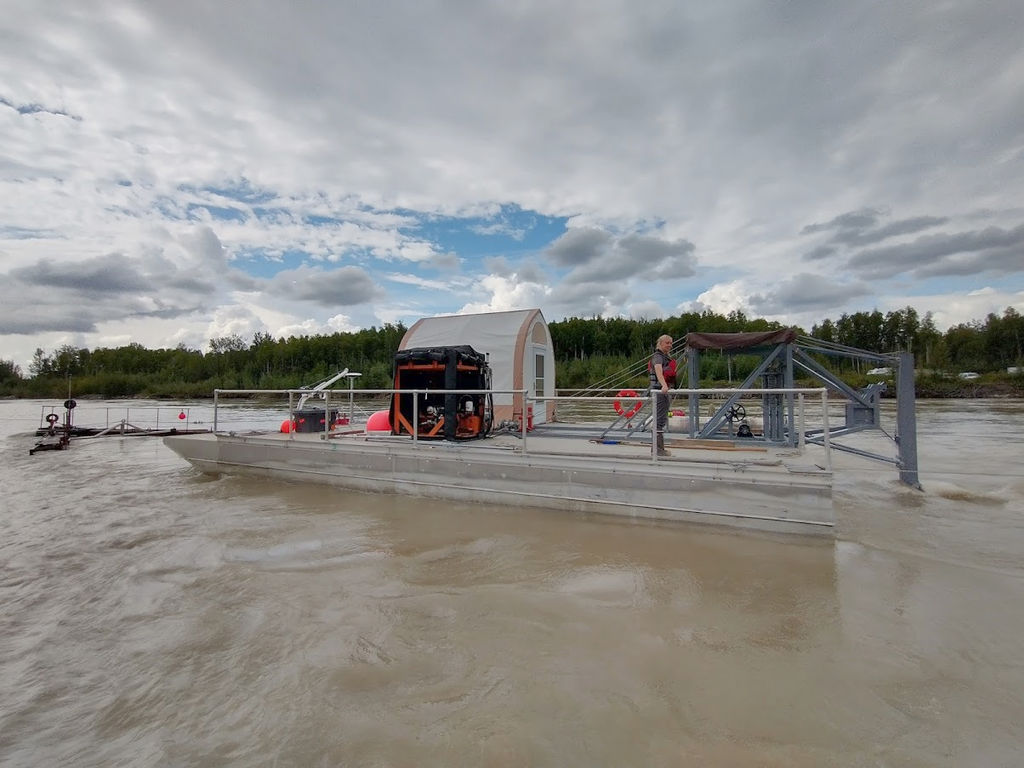 PMEC researcher Emily Browning stands on the barge at the Tanana River Test Site (Courtesy of University of Alaska Fairbanks/Photo by Ben Loeffler)