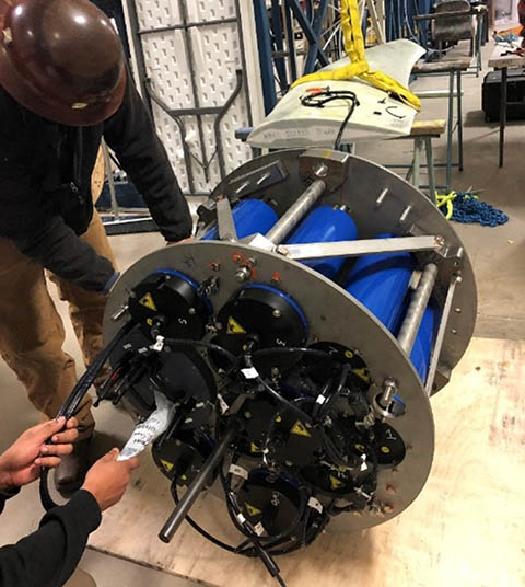 Photo showing NREL researchers connecting a tidal turbine blade to the data acquisition system for validation (Photo by Robynne Murray - NREL)
