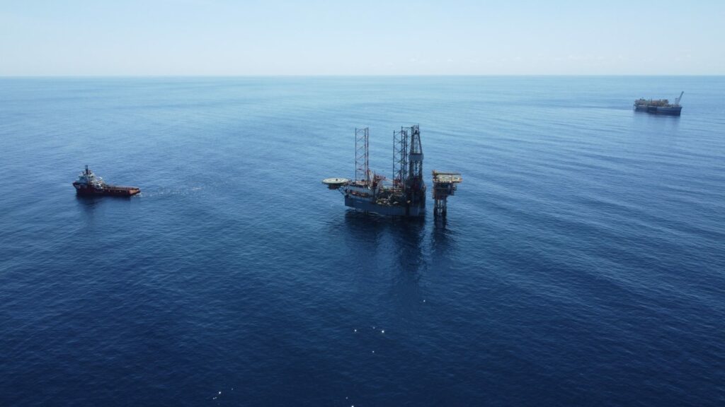 Valaris 107 rig preparing to jack up over the Montara WHP For H6 drilling campaign with Montara FPSO in the background