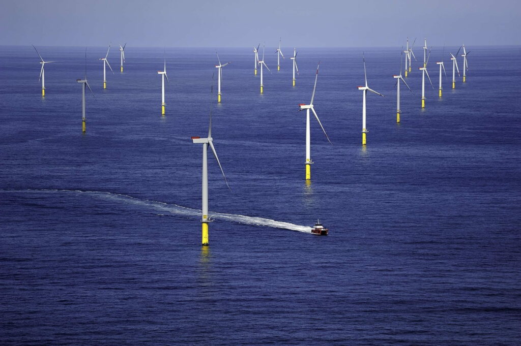 A crew transfer vessel at an offshore wind farm, aerial view