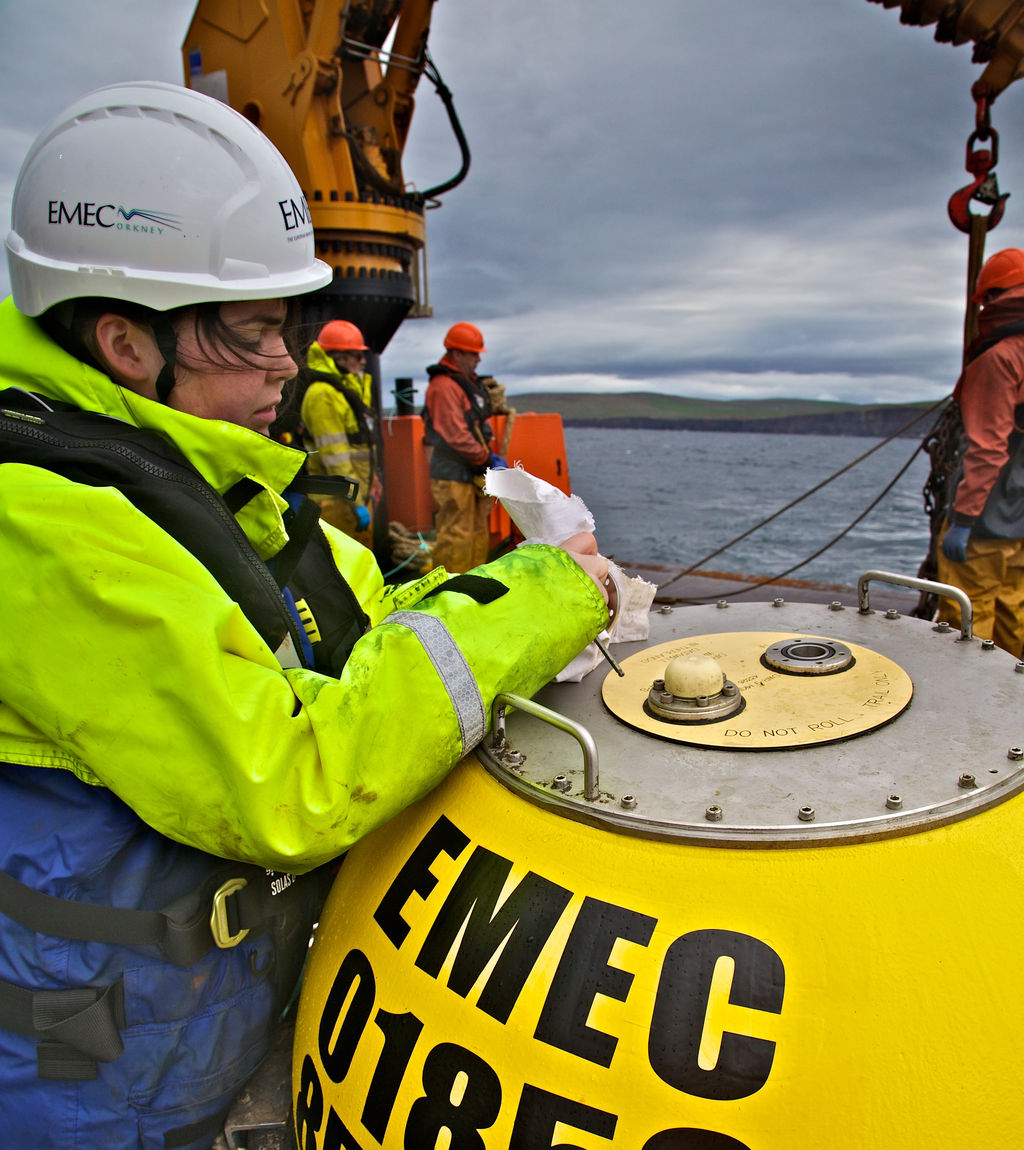Photo showing EMEC’s operations technician preparing waverider buoy for deployment (Courtesy of EMEC/Photo by Colin Keldie)