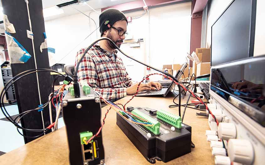 NREL's research engineer Aidan Bharath (Courtesy of NREL/Photo by Dennis Schroeder)