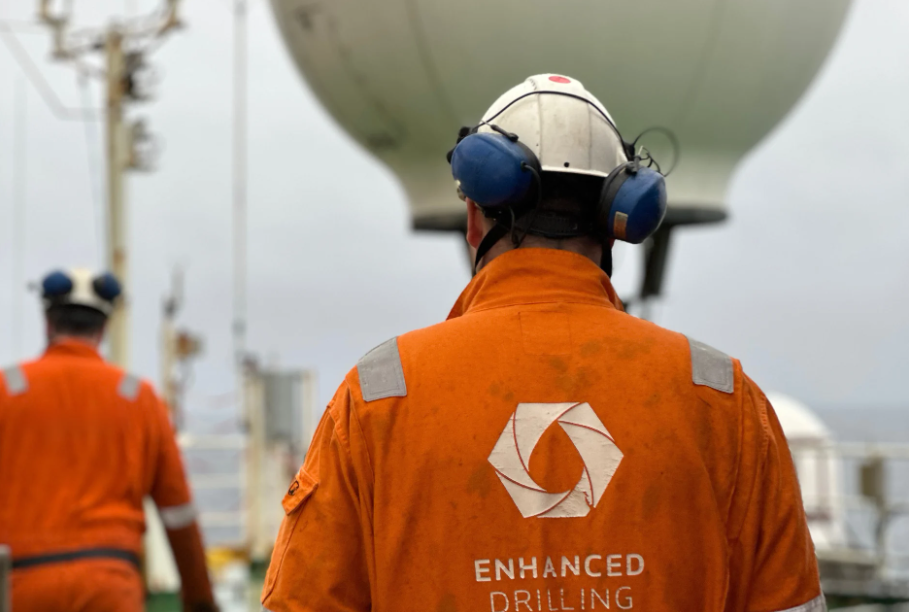 Enhanced Drilling's workers in orange uniforms