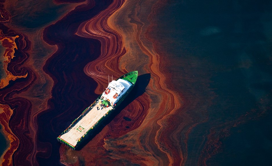 A boat sailing through an oil spill