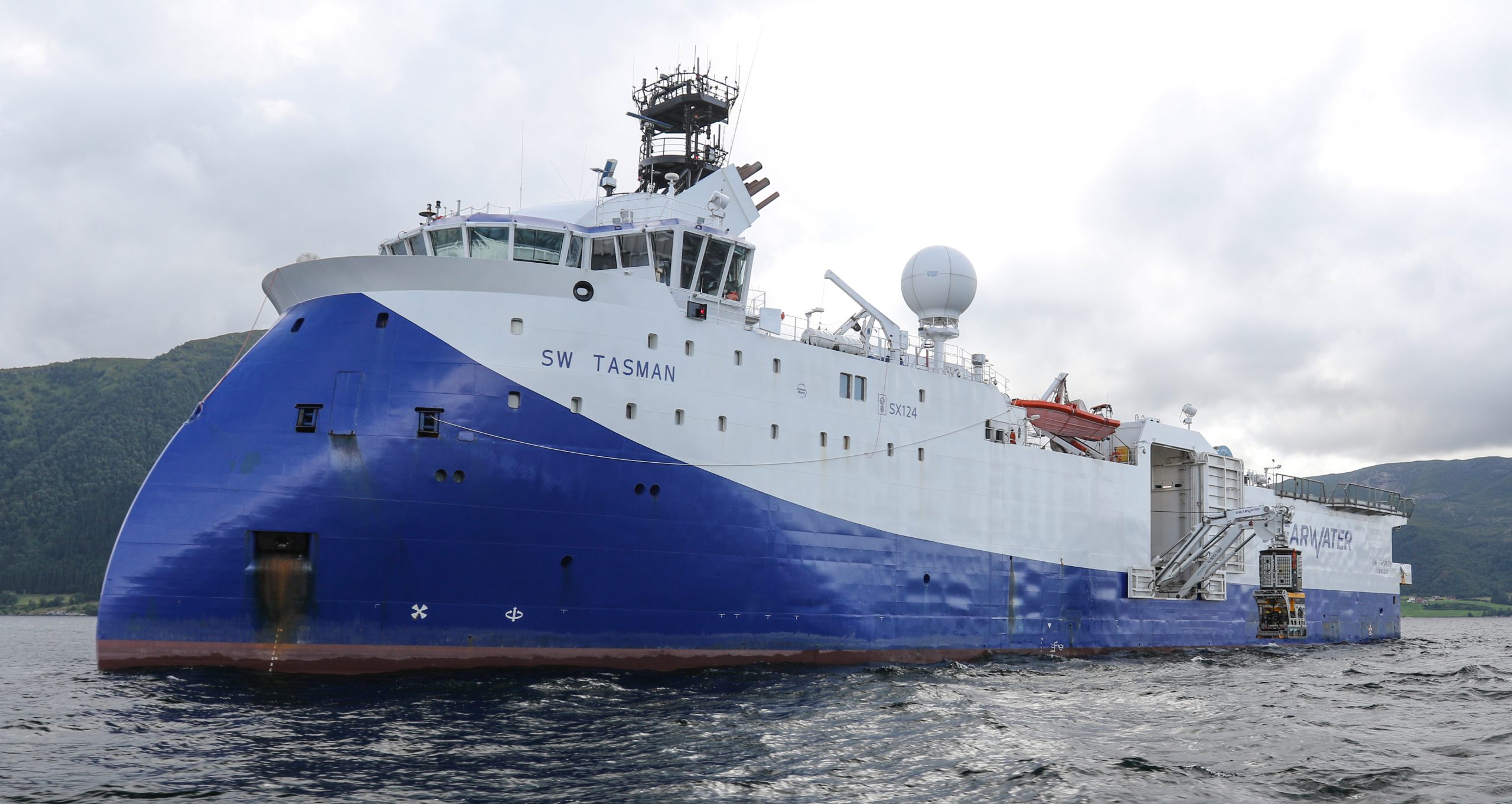 blue and white vessel named SW Tasman