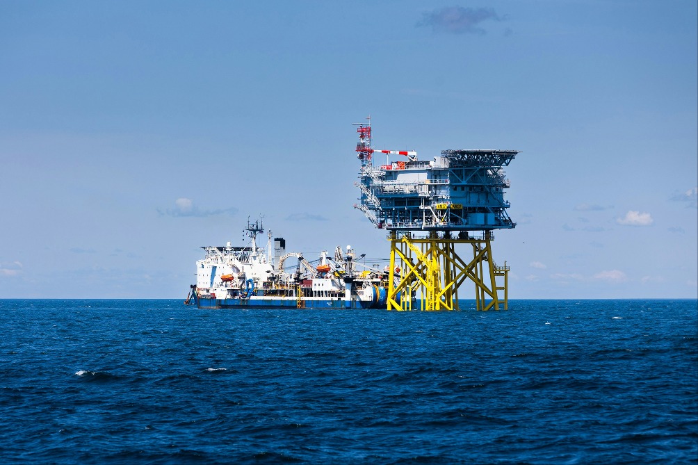 A vessel next to an offshore platform