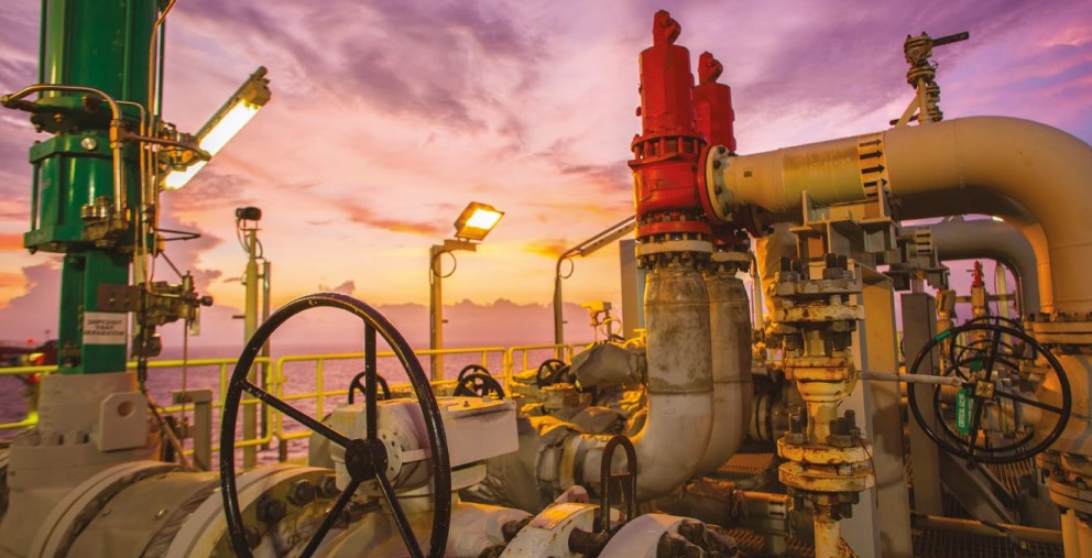 A view of pipes seemingly located offshore at sunset