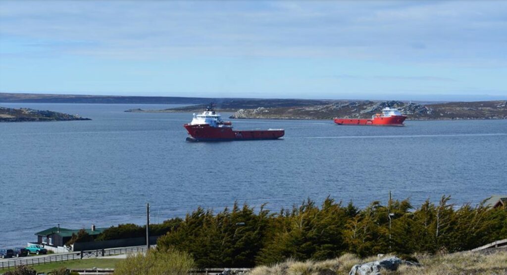 A view of the coast and two vessels at sea