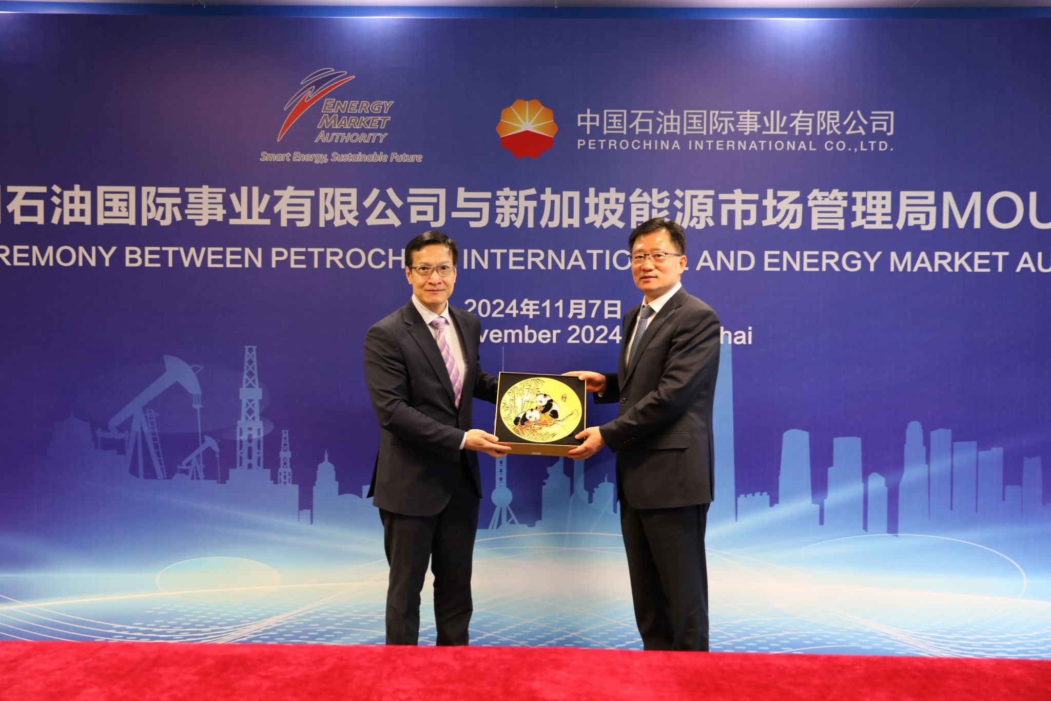 Two men holding a commemorative plaque