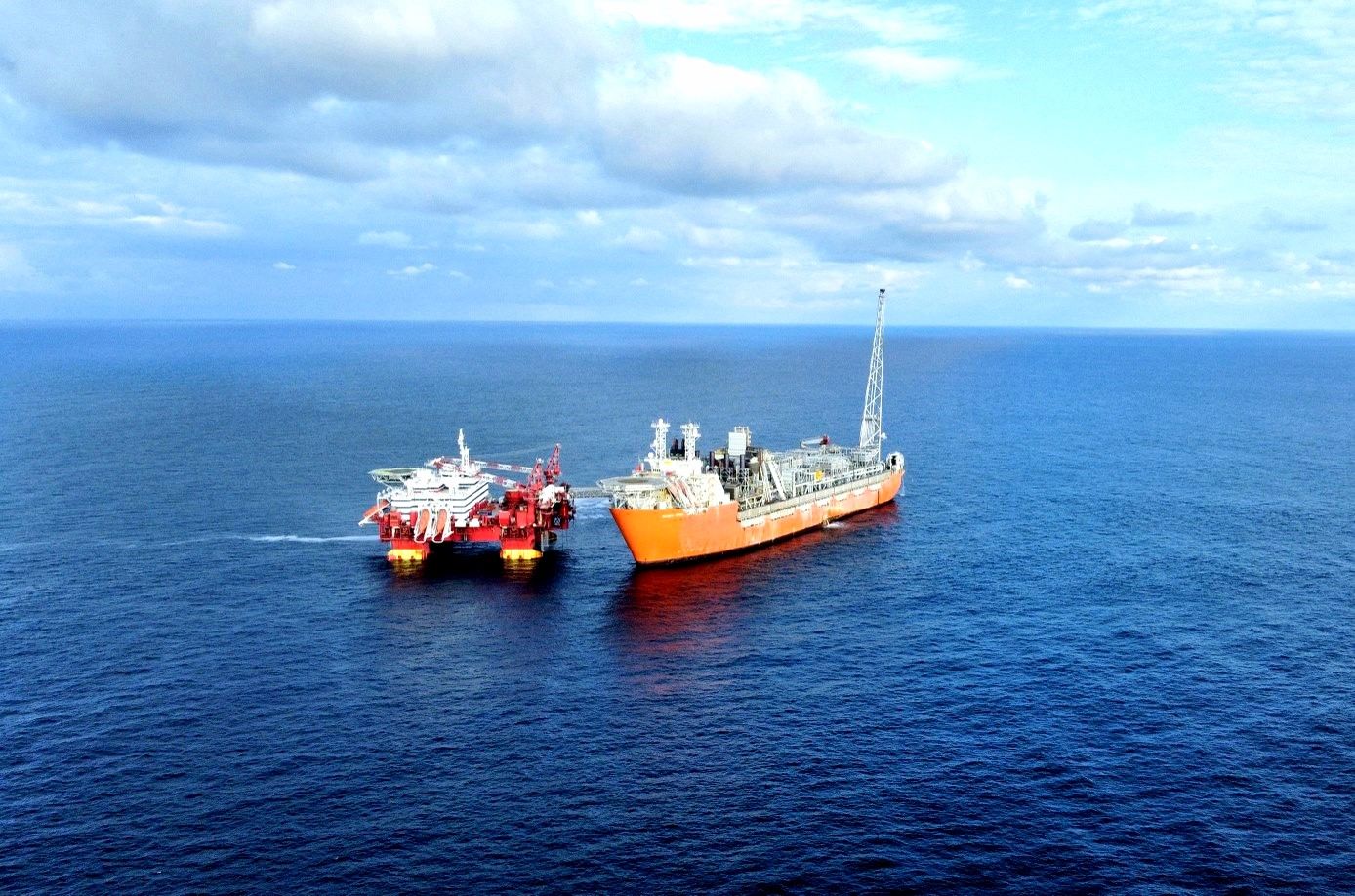 A large vessel next to an offshore platform