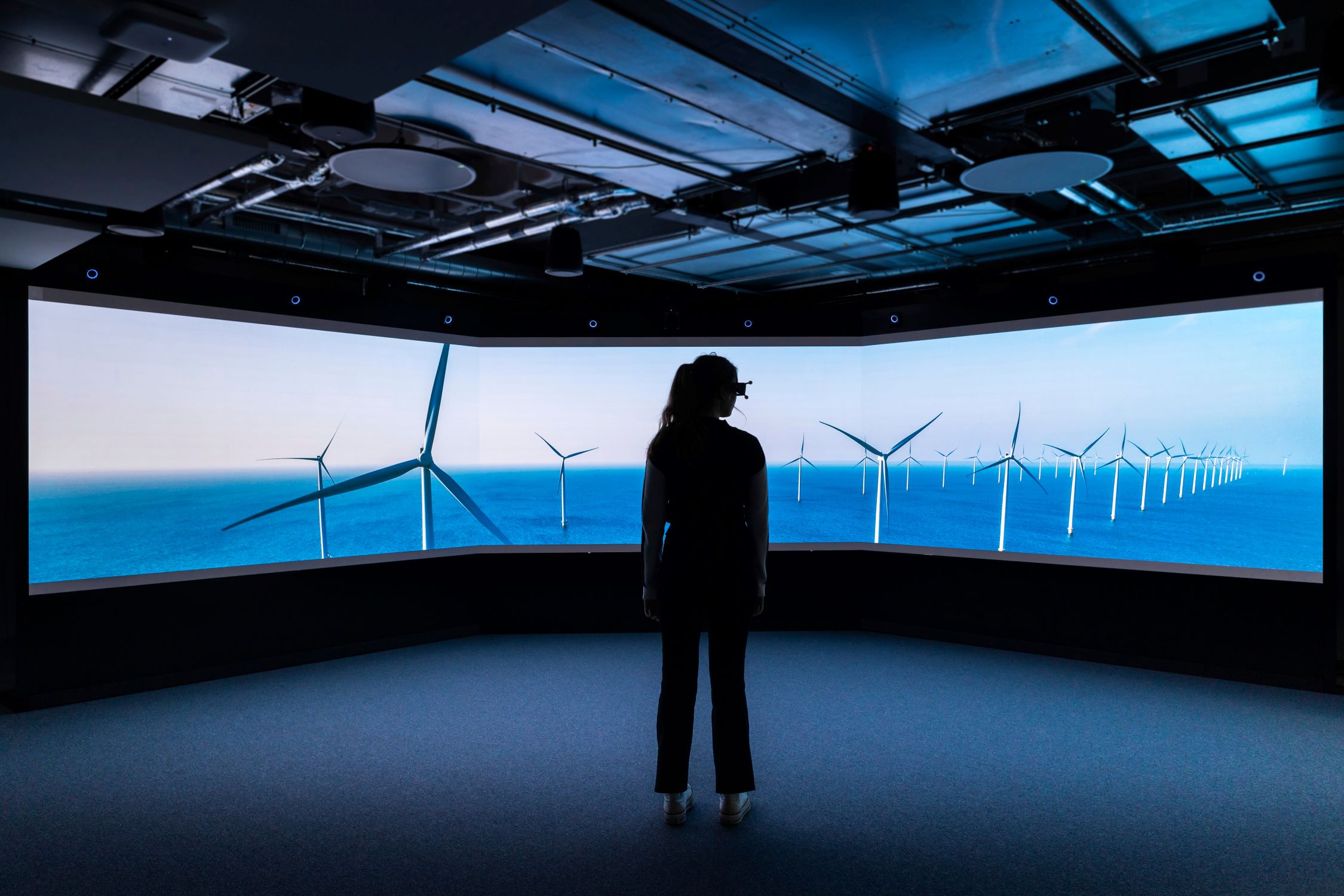 A girl standing in an observatorium looking at offshore wind structures. Source: University of Plymouth