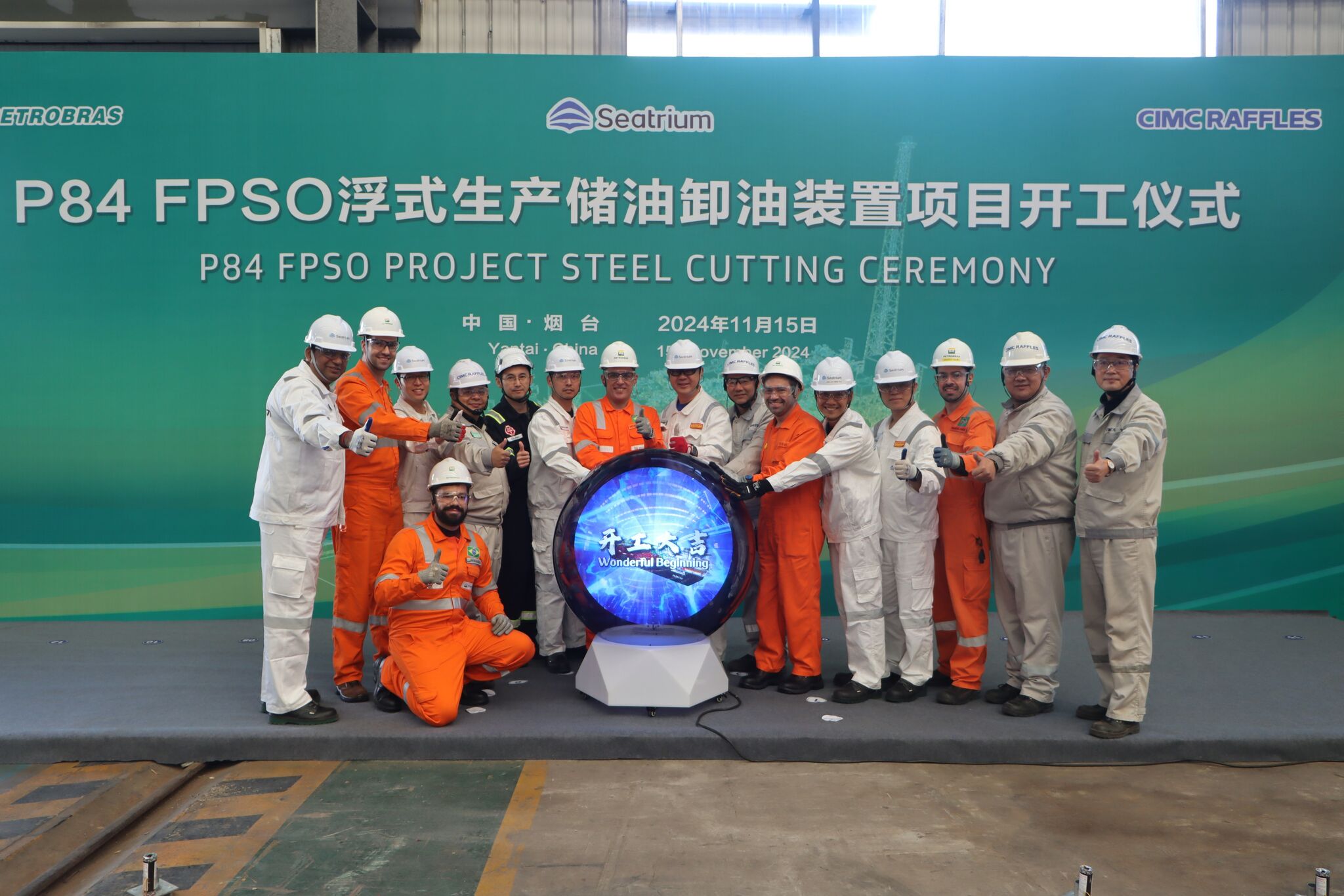 Engineers standing in line in front of a large sign