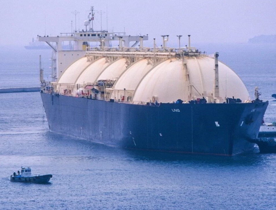 A large vessel at sea with two smaller ones next to it