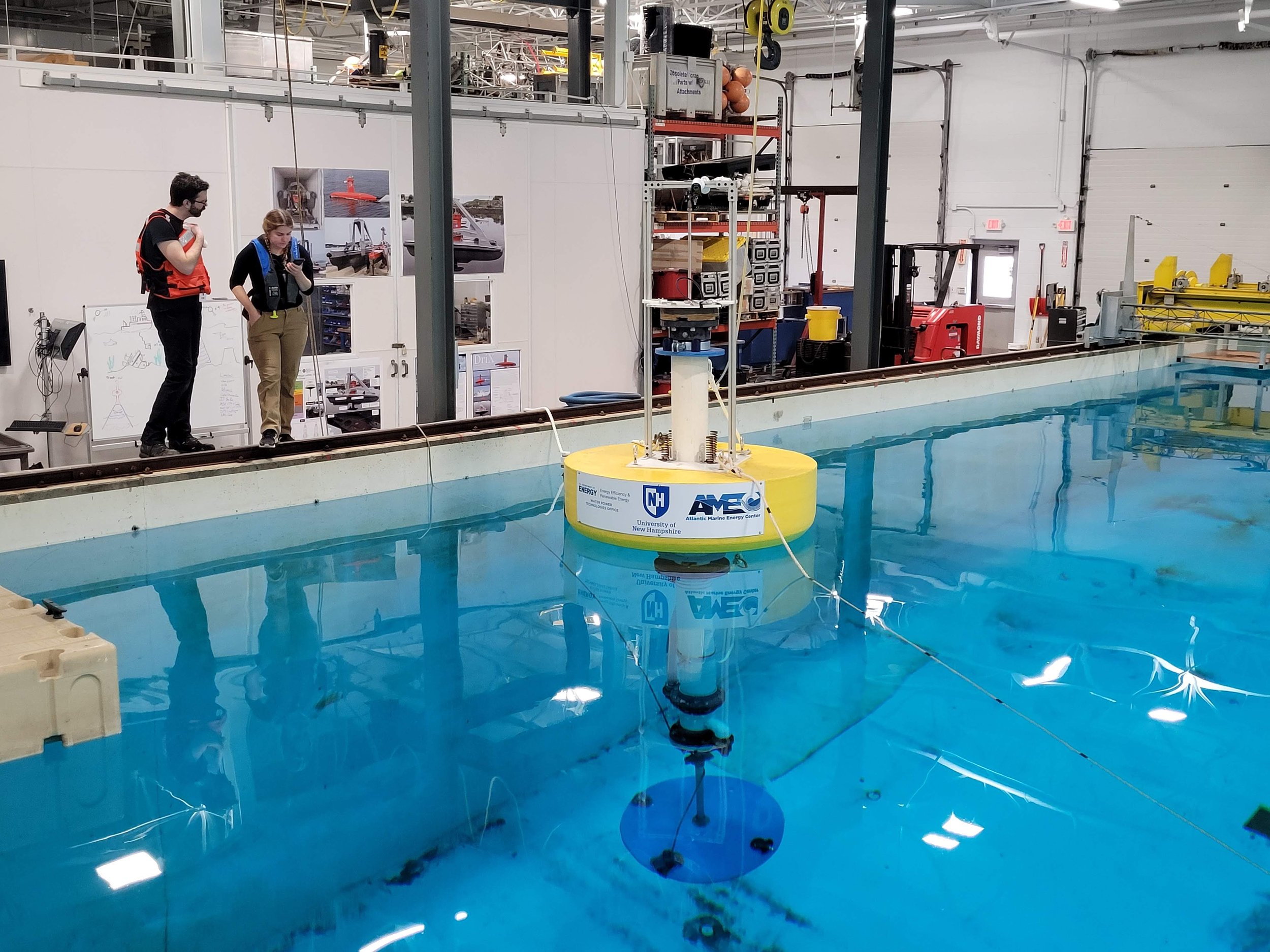 wave energy converter with "AMEC" written on in in a testing tank