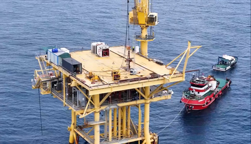 An offshore platform with two vessels approaching