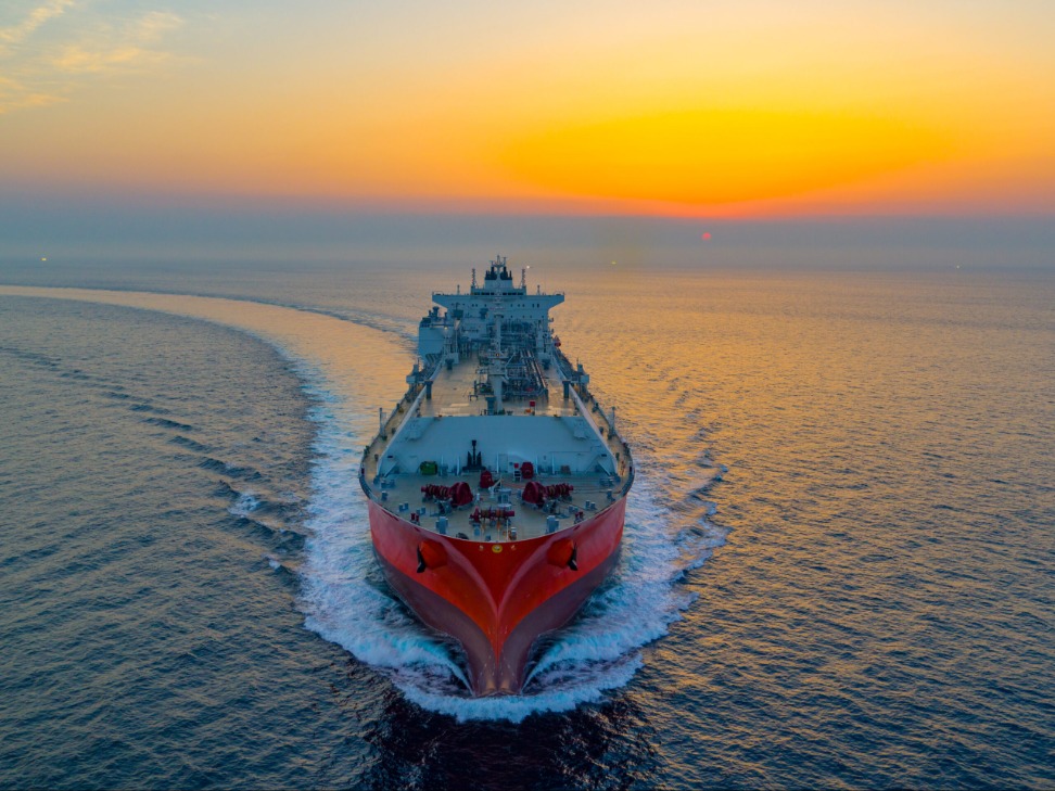 A vessel at sea at sunset