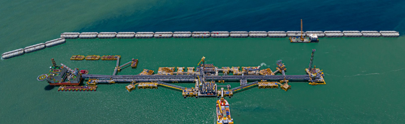 Aerial view of a large vessel and offshore infrastructure