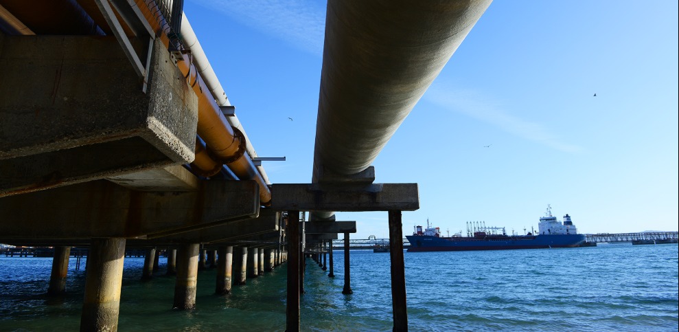 View of a dock with a large vessel in the background