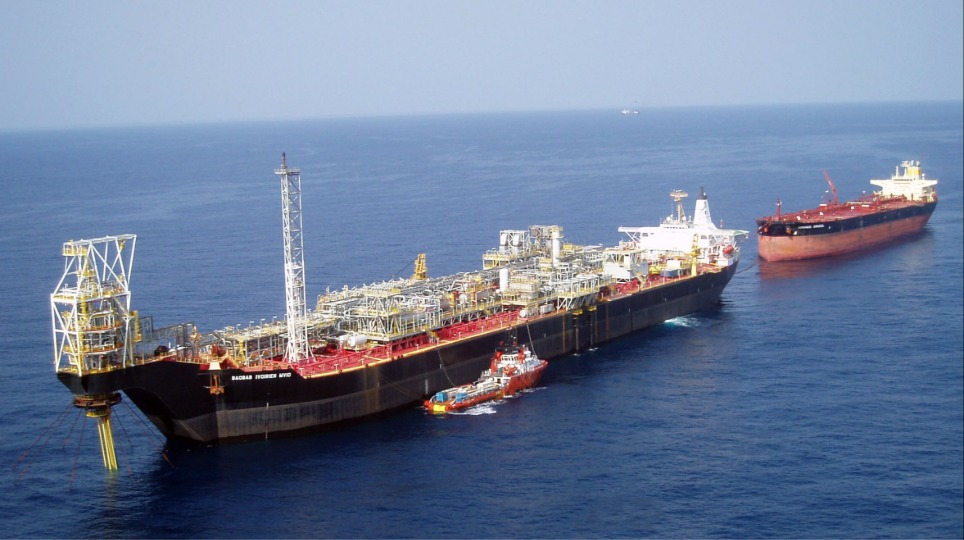 A large vessel at sea with two smaller vessels behind and next to it