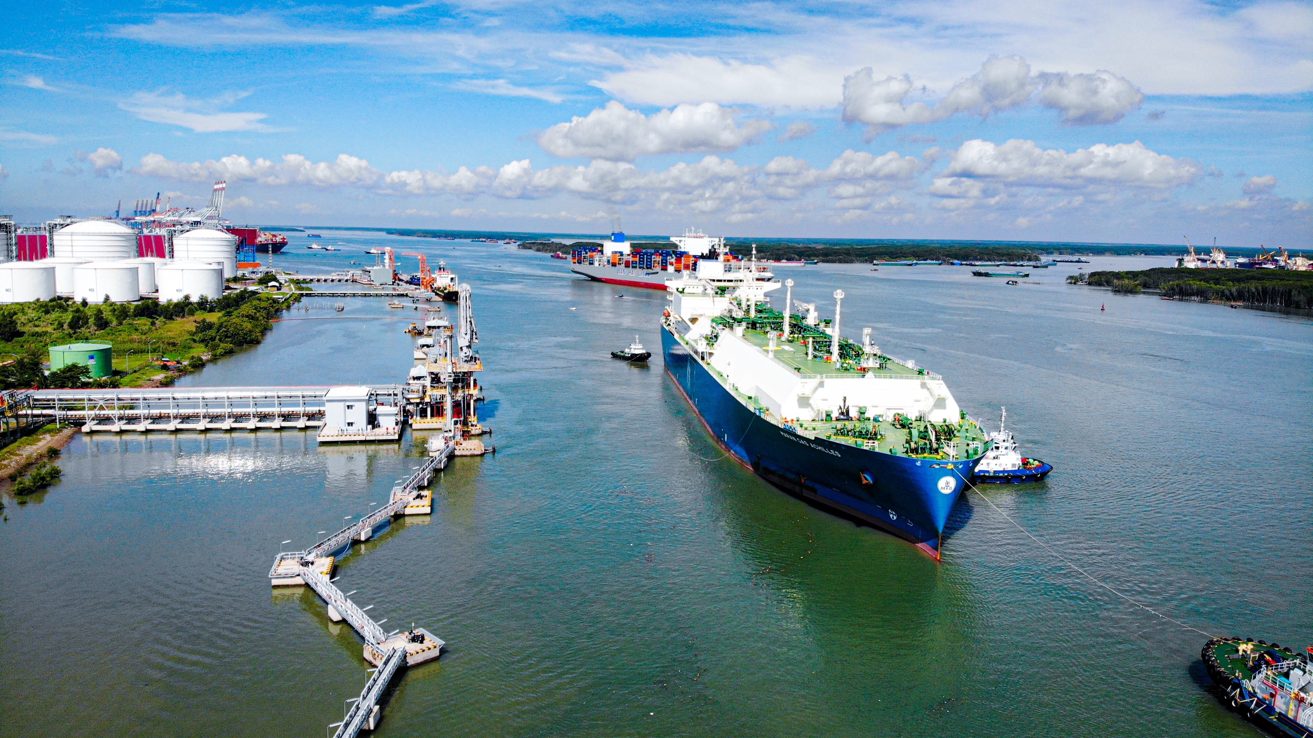 A large ship next to an LNG terminal