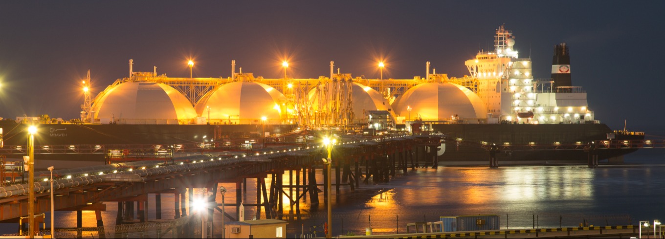 An LNG vessel at dock at night