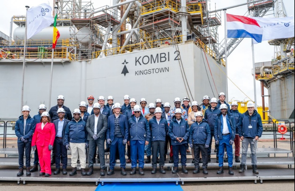 Several people standing in front of a vessel